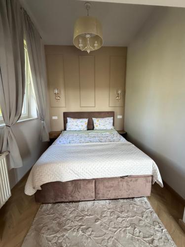 a bedroom with a large bed with a rug at Apartamenty u Gruzina in Ruda