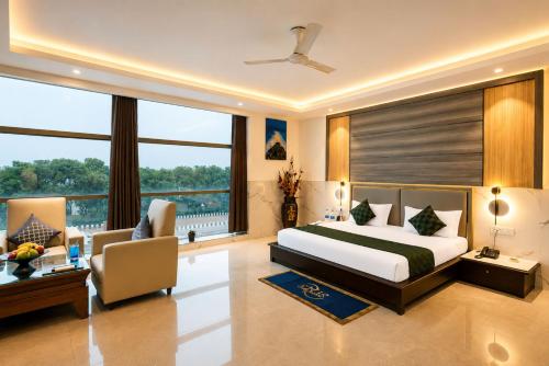 a bedroom with a bed and a desk and a couch at Hotel Delhi 37 by Star Group in New Delhi