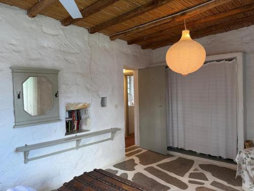 a living room with a chandelier hanging from the ceiling at 3 Bd Stonehouse with Swimming Pool in Paraspóri