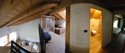 a room with a large wooden ceiling in a house at Tilio Chalet in Livigno