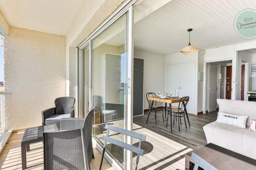 a living room with a couch and a table at Exceptional stay facing the Atlantic Sea-view apartment with balcony in Saint-Gilles-Croix-de-Vie