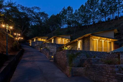 a row of houses with lights on them at night at Rakkh Resort, a member of Radisson Individuals Retreats in Pālampur