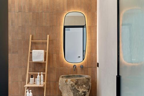 a bathroom with a sink and a mirror at Villa Orama Corfu in Karyótikon