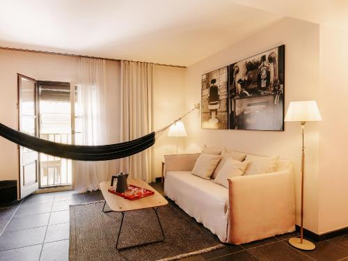 a living room with a couch and a table at Casa Camper Barcelona in Barcelona