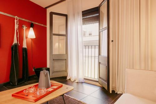 a red room with a table with wine glasses on it at Casa Camper Barcelona in Barcelona