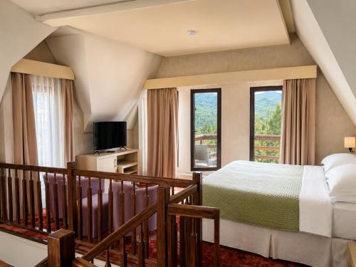 a bedroom with a bed and a balcony at Ioana Boutique Hotel in Sinaia