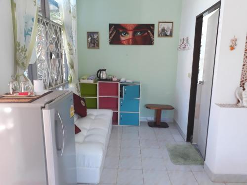 a living room with a couch and a refrigerator at Rerawadi Resort in Khun Han