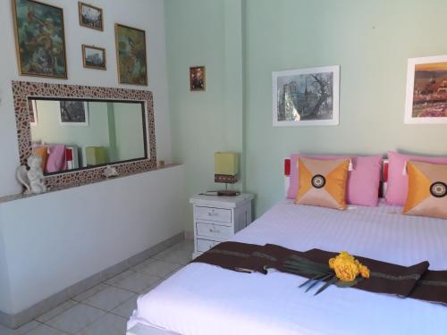 a bedroom with two beds and a mirror at Rerawadi Resort in Khun Han