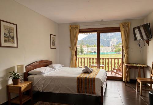 a bedroom with a bed and a window with a balcony at Balcon de Gocta in Cocachimba