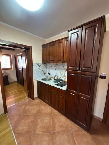 a kitchen with wooden cabinets and a counter top at Villa Roselina By Beatrix in Budva