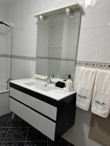 a bathroom with a sink and a mirror at Praia - Mar in Ovar