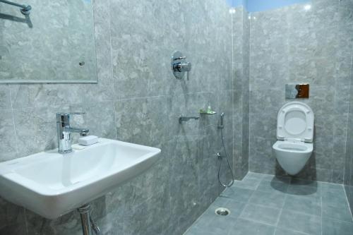 a bathroom with a sink and a toilet at SILVER REGENCY in Guwahati
