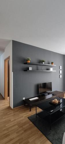 a living room with a table and a fireplace at Corvin Center Suites in Budapest