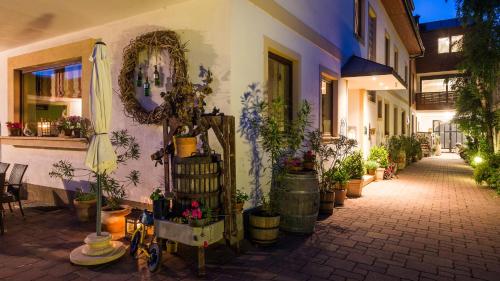 a street with potted plants on the side of a building at Pension Julia & Haus Elisabeth - Wallner's Hofheuriger & Weinhof in Mörbisch am See