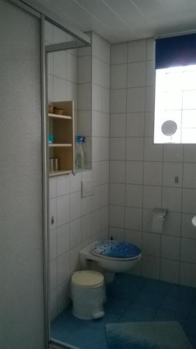 a bathroom with a toilet and a sink at Apartment Meyerhof in Schwanau