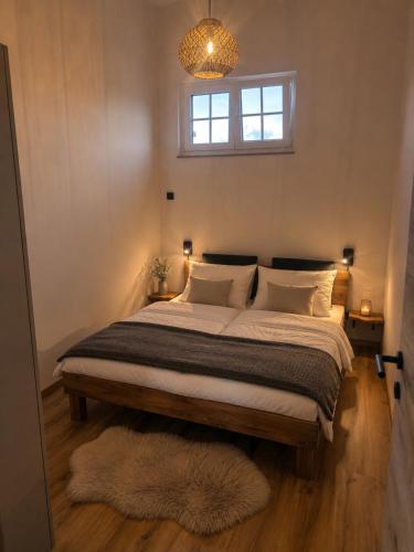 a bedroom with a large bed with a window at Blockhaus am Edersee in Vöhl