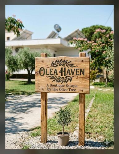 a sign in front of a house with a potted plant at Olea Heaven Aliveri in Aliveri