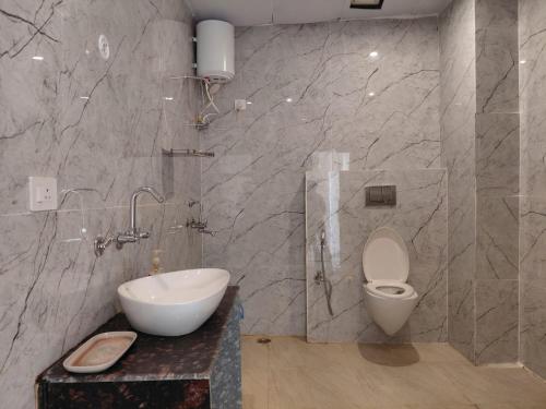 a bathroom with a sink and a toilet in it at Ravira Resort in Sītāpur