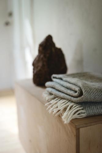 a pile of towels on a counter with a rock at Retreat House in Lauvas