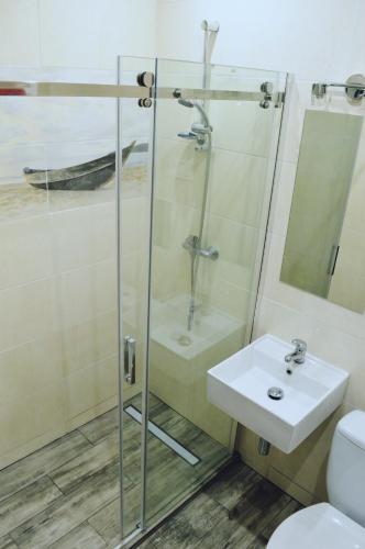 a bathroom with a sink and a shower at Apartament Stogi in Gdańsk