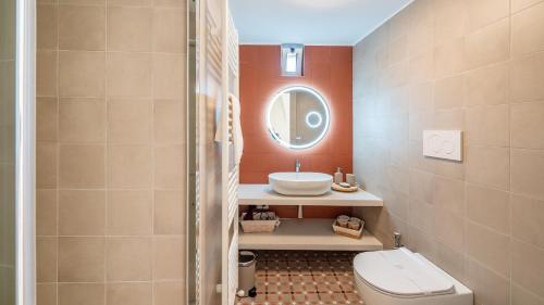 a bathroom with a sink and a toilet and a mirror at Casa Cenzina by Rentbeat in Locorotondo