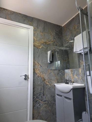 a bathroom with a toilet and a sink and a shower at Corner Lodge in Eltham