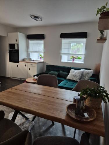 a living room with a table and a couch at Apartmán U Lanovky in Kramolín