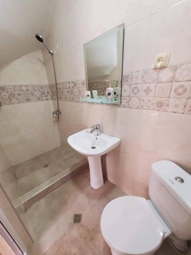 a bathroom with a toilet and a sink and a shower at cozy wave house ureki in Ureki