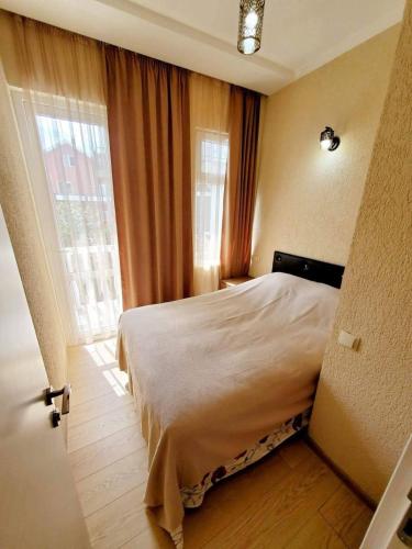 a bedroom with a bed and a large window at cozy wave house ureki in Ureki