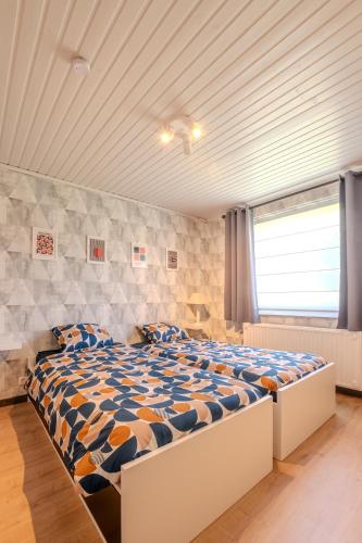 a bedroom with a large bed in a room at Gîte Ô16 in Nassogne