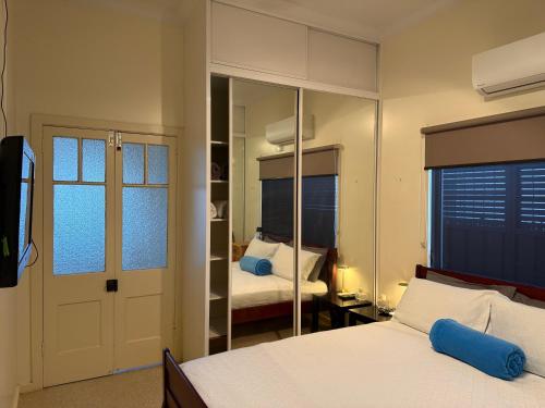 a bedroom with a bed and a mirror at Lake Macquarie holidays in Marks Point