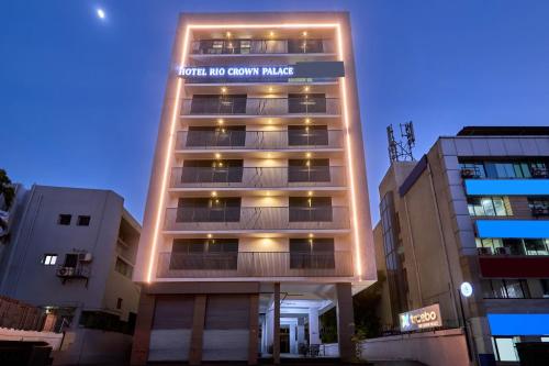 a tall building with a sign on top of it at Treebo Rio Crown Palace in Ahmedabad