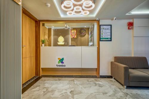 a waiting room with a window with two donuts at Treebo Rio Crown Palace in Ahmedabad