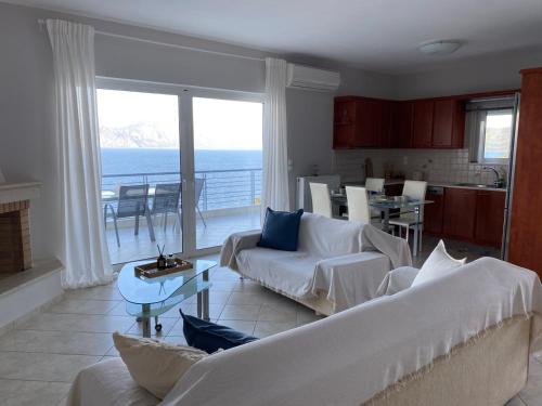 a living room with a view of the ocean at Blue Deck Theologos in Theologos