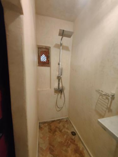 a small bathroom with a shower in a room at Dar Imran in Tangier