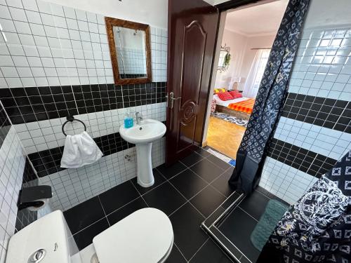 a bathroom with a white toilet and a sink at Miti Retreat Nanyuki in Naro Moru