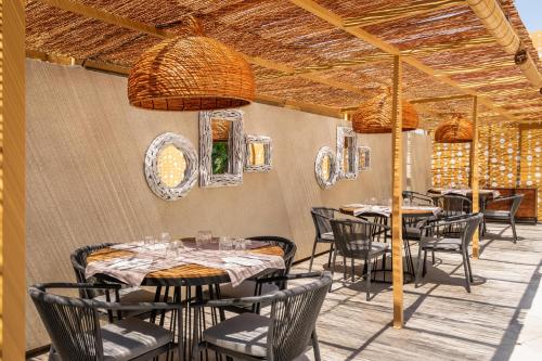 a restaurant with tables and chairs on a patio at ALEGRIA Cartago Nova in Malgrat de Mar