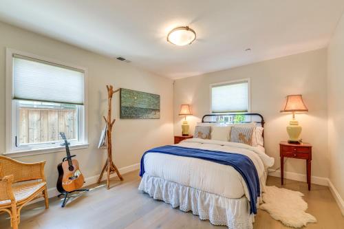 a bedroom with a bed and a guitar in it at Walkable Mill Valley Gem: Private Patio + Yard in Mill Valley