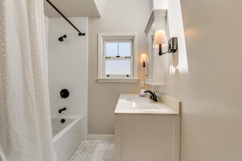 a white bathroom with a sink and a shower at Walkable Mill Valley Gem: Private Patio + Yard in Mill Valley
