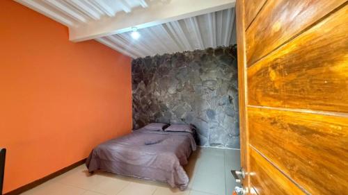 a small bedroom with a bed in the corner at Jayagiri Inn in Tangkubanperahu