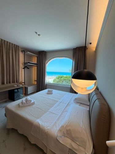 a bedroom with a large bed with a large window at Hotel Santa Lucia in Termoli