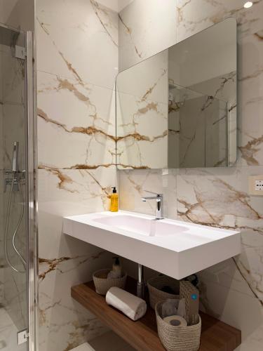 a bathroom with a white sink and a mirror at Hotel Santa Lucia in Termoli