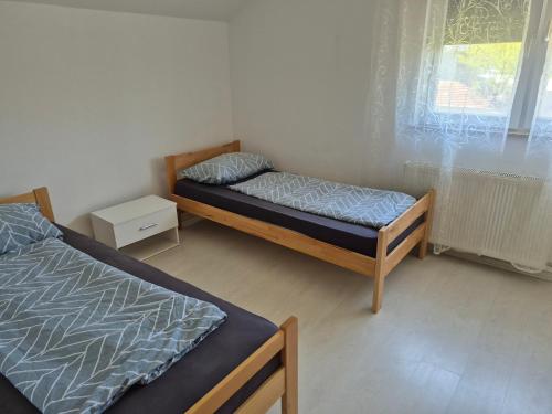 a bedroom with two beds and a window at Villa Sunset in Podastrana