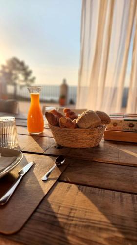 a bowl of bread and a bowl of fruit on a table at Quinta O Ninho Bed & Breakfast in Monchique