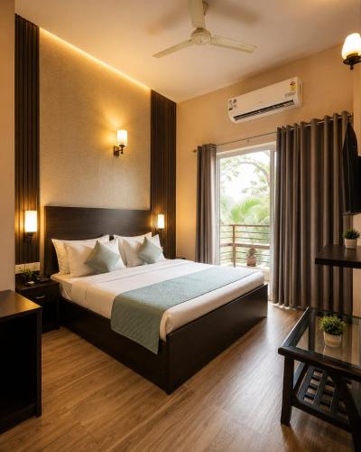 a bedroom with a large bed and a window at Nandan Retreat 4-Star Hotel & Luxury Villas Near Prem Mandir, Vrindavan in Vrindāvan