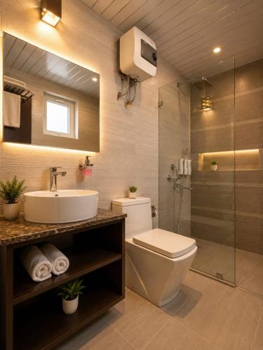 a bathroom with a toilet and a sink and a shower at Nandan Retreat 4-Star Hotel & Luxury Villas Near Prem Mandir, Vrindavan in Vrindāvan