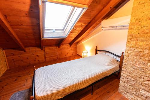 a bedroom with a bed in a room with a window at Holiday Home Potidaia in Nea Potidaea