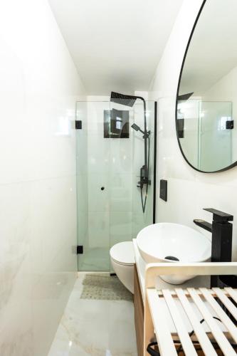 a bathroom with a sink and a shower at Holiday Home Potidaia in Nea Potidaea