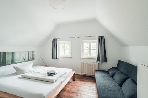 a living room with a bed and a couch at Schneekäppchen 1 in Winterberg