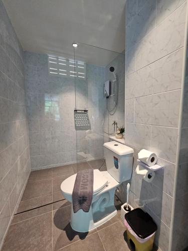 a bathroom with a toilet and a shower at Candy Beach Seaview Jomtien in Jomtien Beach